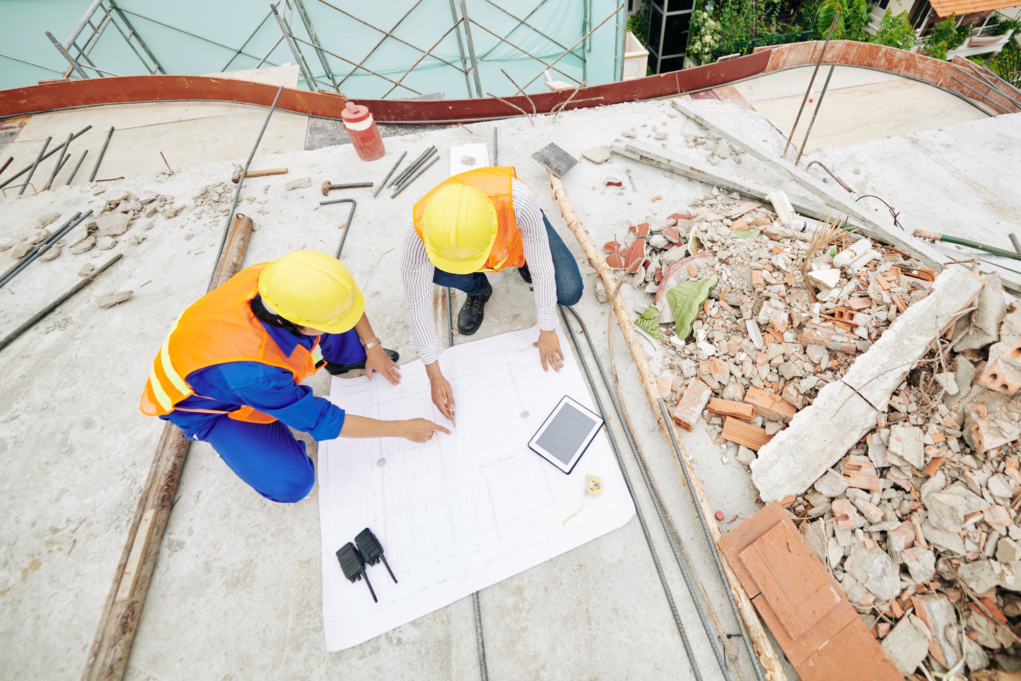 Civil engineers pointing at building plan