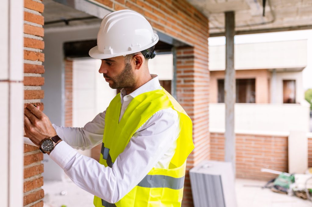 Smart civil architect engineer inspecting indoor construction building site